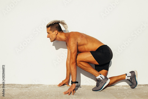 Fit man getting ready for the  running