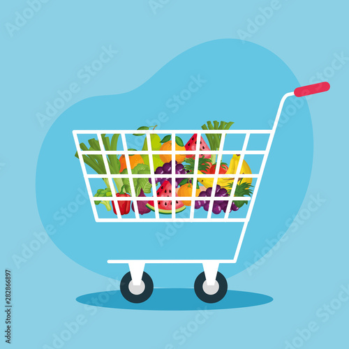 shopping car with healthy fruits and vegetables
