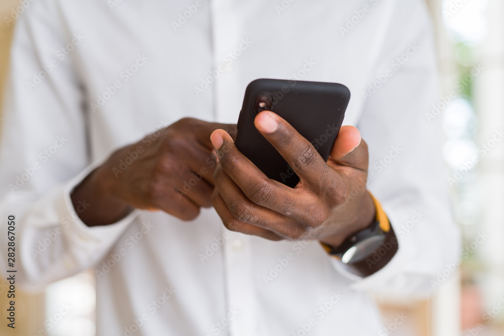 Close up of african man hands using smarpthone Close up of african man hands using smarpthone
