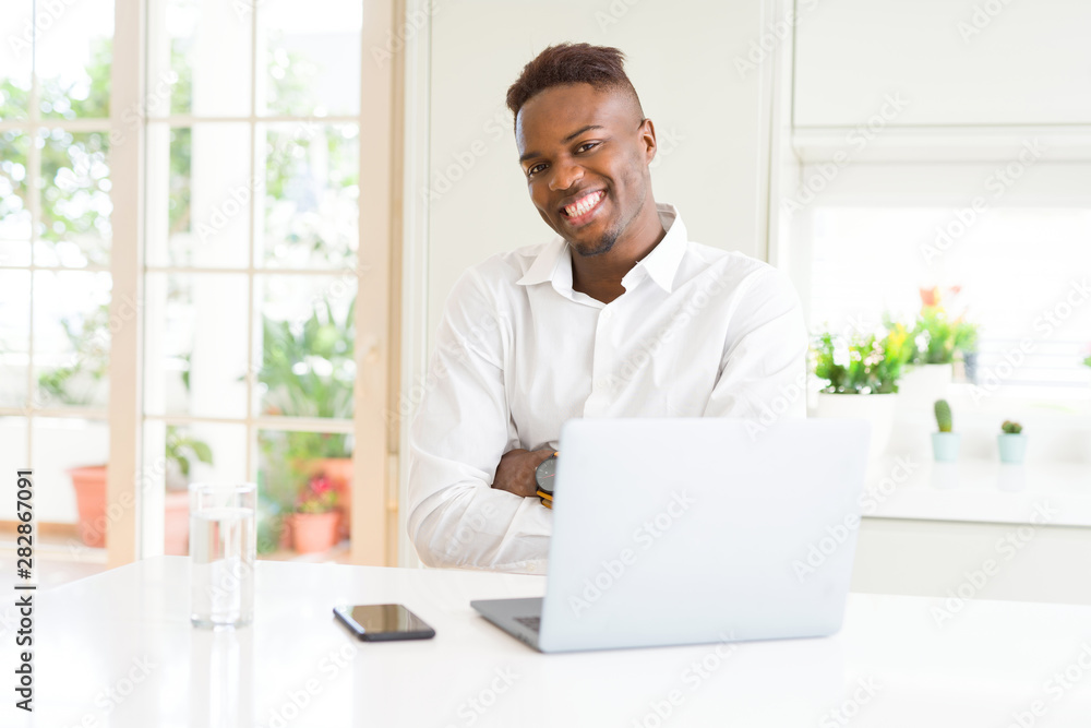 African american business man working using laptop happy face smiling with crossed arms looking at the camera. Positive person. African american business man working using laptop happy face smiling with crossed arms looking at the camera. Positive person.