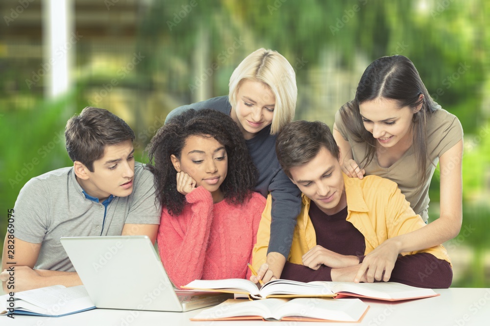 Four Young students studying subject on background Four Young students studying subject on background