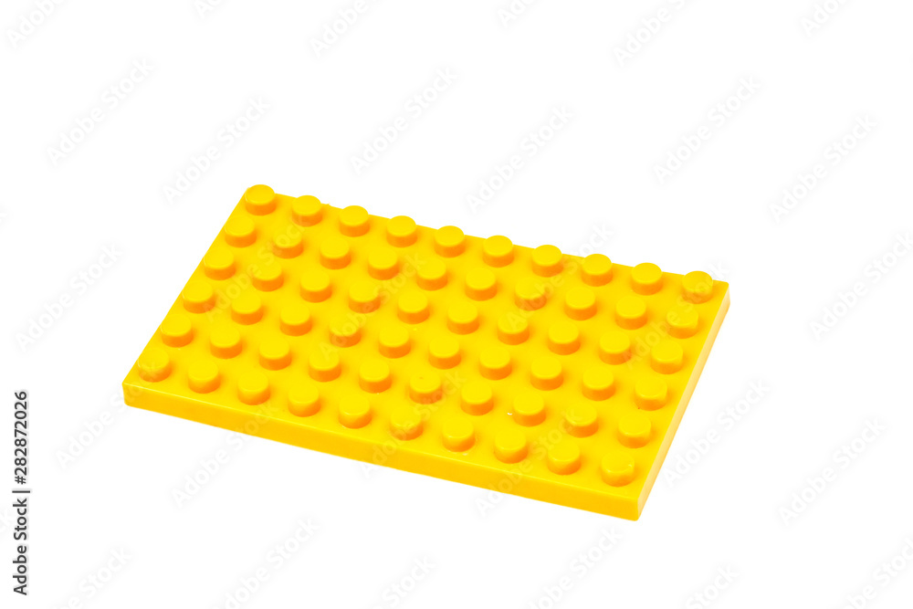 Yellow plastic building block isolated on white background. Developmental toys for children. Yellow plastic building block isolated on white background. Developmental toys for children.