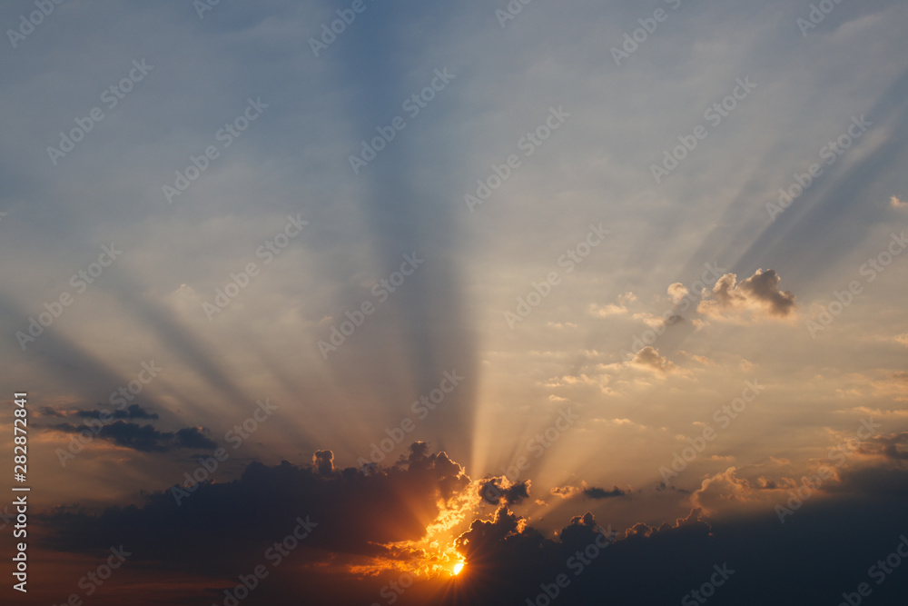 Sunset between clouds forming the rays a spectacular twilight Sunset between clouds forming the rays a spectacular twilight