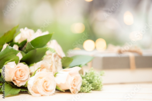 blur background rose flower on wooden table with gift box and copy space