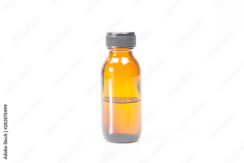 Brown glass bottle and black plastic bottle cap isolated on white background. Brown glass bottle and black plastic bottle cap isolated on white background.