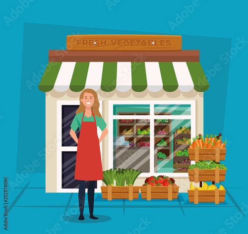 saleswoman with apron and healthy vegetables and fruits