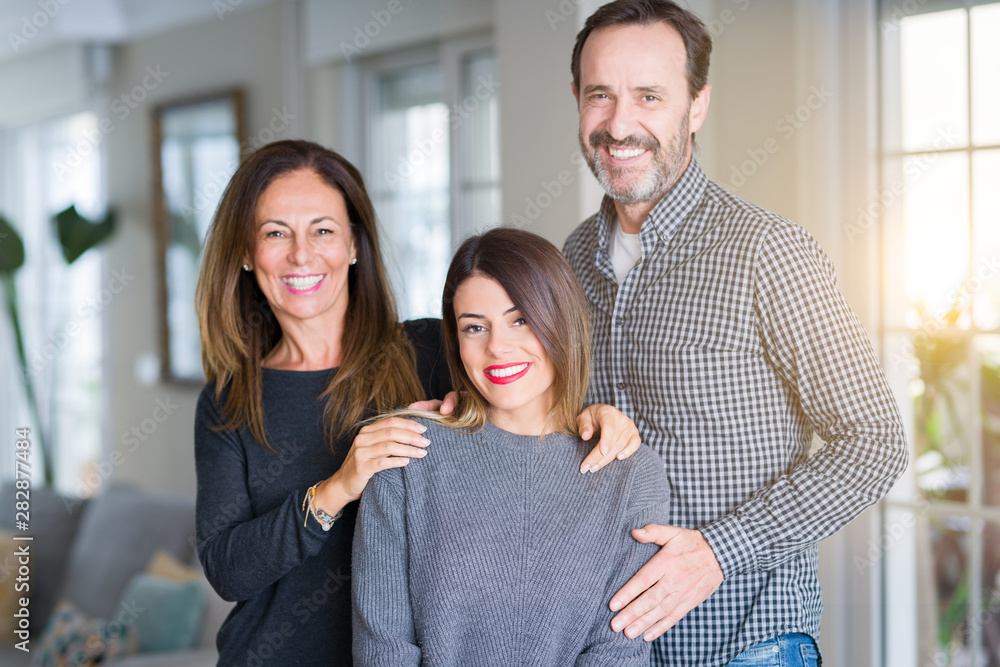 Beautiful family together. Mother, father and daughter smiling and hugging with love at home. Beautiful family together. Mother, father and daughter smiling and hugging with love at home.