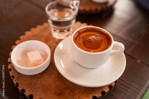 Turkish coffee served with turkish delight lokum photo