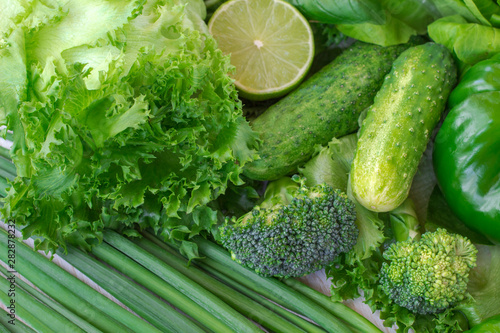Healthy green vegetables: broccoli, lettuce, onions and lime.