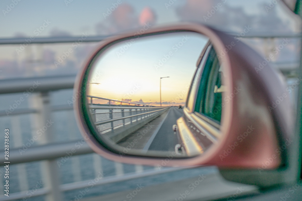 road landscape in a car rearview mirror