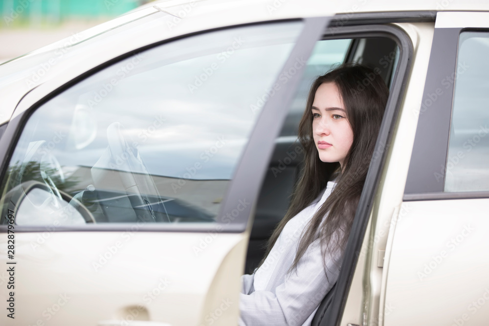 Young girl in the car. Beautiful woman driving Young girl in the car. Beautiful woman driving
