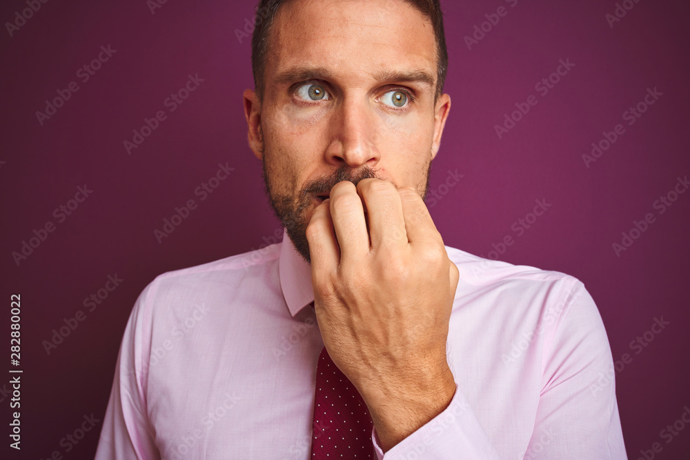 Close up of business man wearing elegant shirt and tie over purple isolated background looking stressed and nervous with hands on mouth biting nails. Anxiety problem. Close up of business man wearing elegant shirt and tie over purple isolated background looking stressed and nervous with hands on mouth biting nails. Anxiety problem.
