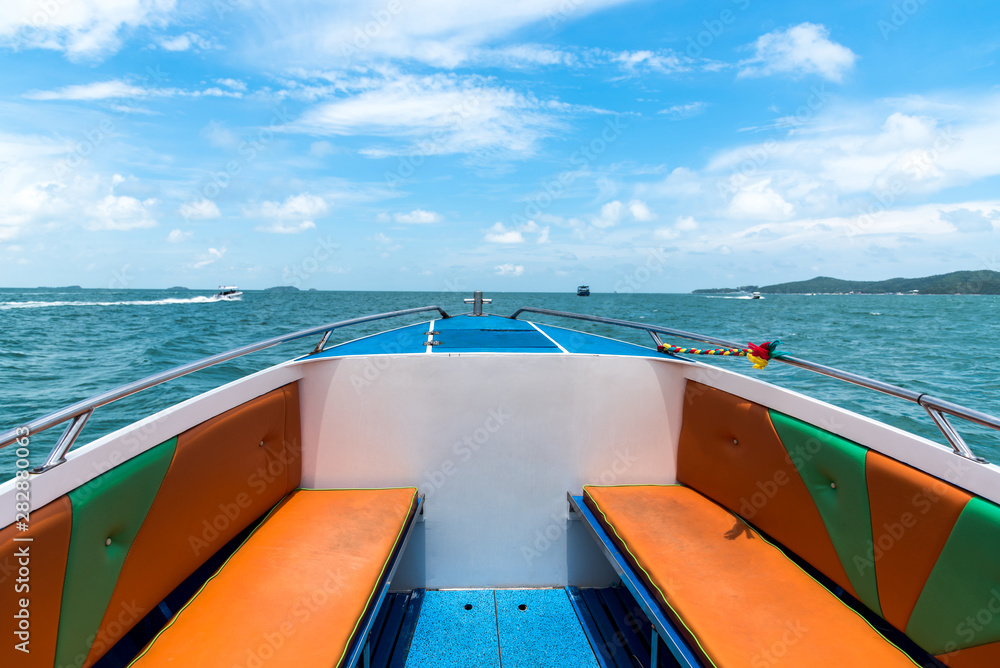 The front of the Speed boat is moving out to the sea in summer and take tourists to the island in Thailand with blue sky, white clouds background and copy space.