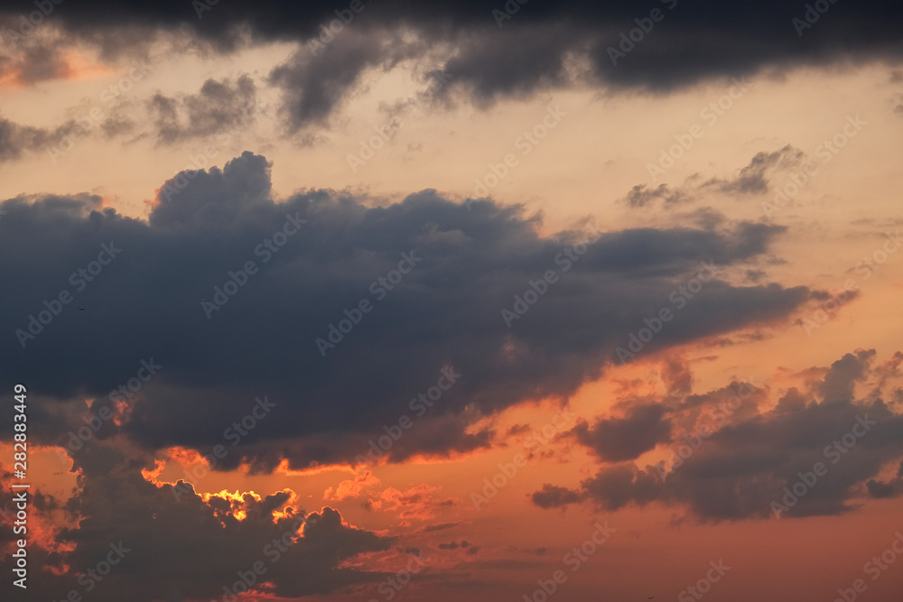 Sunset with grey and black clouds, room for copy