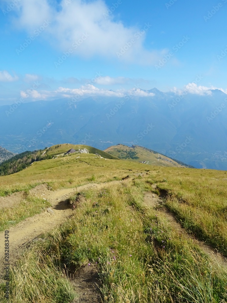 Naklejka premium Nature, meadows and peaks that characterize the landscape of the Italian Alps in Val di Susa, near the village of 