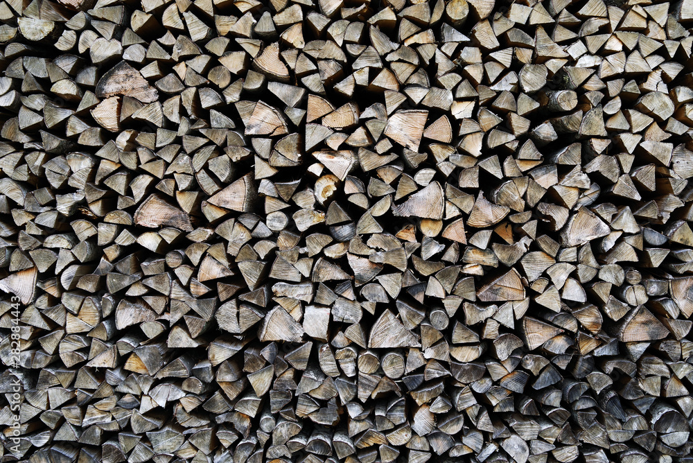 A pile of stacked firewood, prepared for heating the house. Firewood harvested for heating in winter A pile of stacked firewood, prepared for heating the house. Firewood harvested for heating in winter