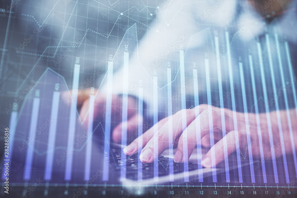 Forex graph with businessman typing on computer in office on background. Concept of analysis. Double exposure. Forex graph with businessman typing on computer in office on background. Concept of analysis. Double exposure.