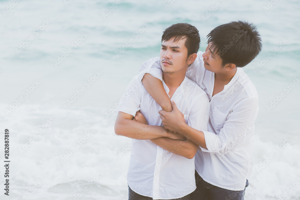 Homosexual portrait young asian couple standing problem on beach in summer, asia gay angry and unhappy in vacation at sea, relationship with disappointed and frustrated, LGBT with legal concept. Homosexual portrait young asian couple standing problem on beach in summer, asia gay angry and unhappy in vacation at sea, relationship with disappointed and frustrated, LGBT with legal concept.