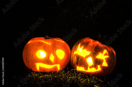 illuminated scary halloween pumpkins shining in dark night