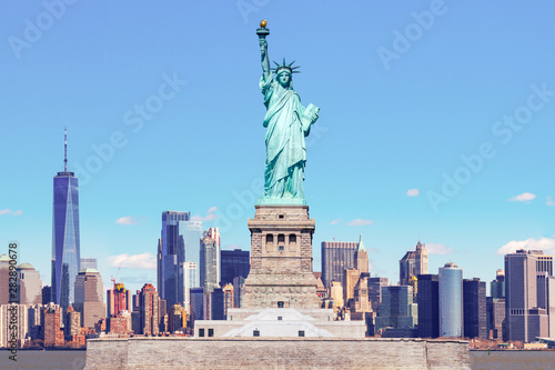 The Statue of Liberty with the One world Trade building center over hudson river and New York cityscape background, Landmarks of lower manhattan New York city. © ChayTee