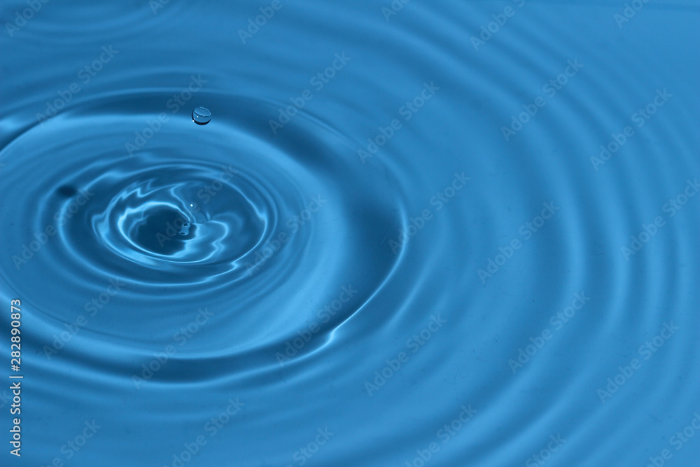 Texture, background with falling water drops and waves with blue water Texture, background with falling water drops and waves with blue water