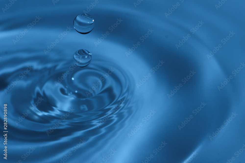 Texture, background with falling water drops and waves with blue water Texture, background with falling water drops and waves with blue water