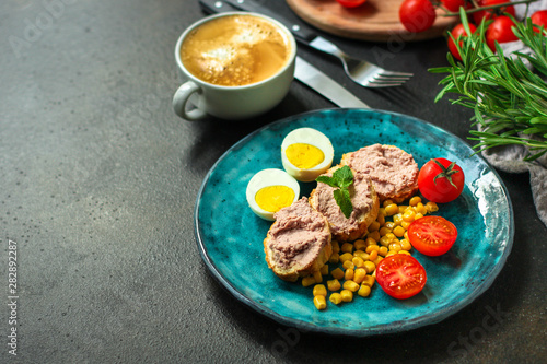 Breakfast snack, tasty food (pate, toast, tomato, corn, egg, coffee). top view. food background. copy space