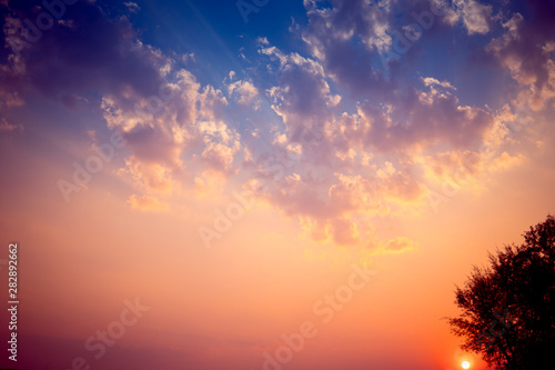 Sunset background with wonderful golden yellow sky.Dusk sky in the evening,amazing dramatic and wonderful cloud at twilight.