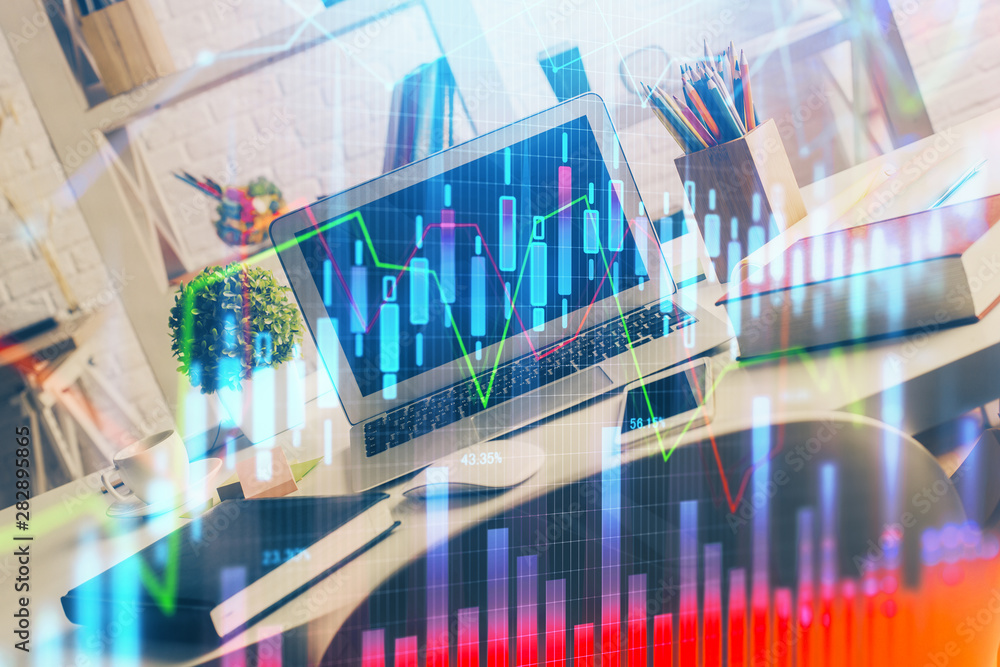 Financial graph colorful drawing and table with computer on background. Double exposure. Concept of international markets. Financial graph colorful drawing and table with computer on background. Double exposure. Concept of international markets.