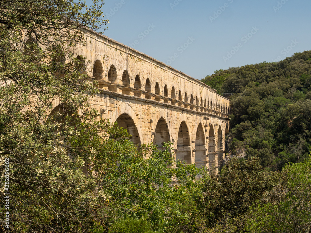 France, July 2019: The beautiful nature of southern France with its famous landmark roman bridge Pont du Gard, located near Avignon