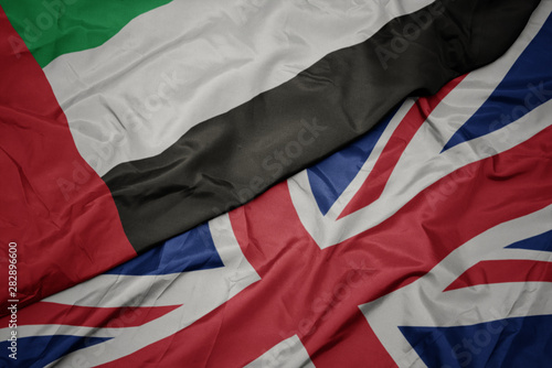 Canvas Print waving colorful flag of great britain and national flag of united arab emirates