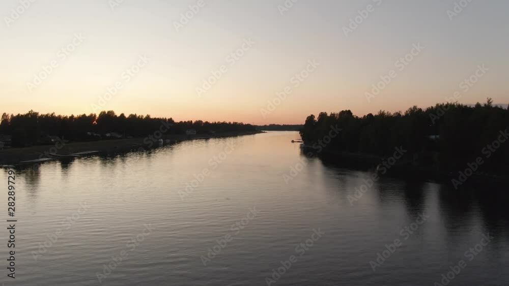 Sunset view. Drone shot of landscape with river. Golden sky and horizon. Reflection in the water. Sunset view. Drone shot of landscape with river. Golden sky and horizon. Reflection in the water.