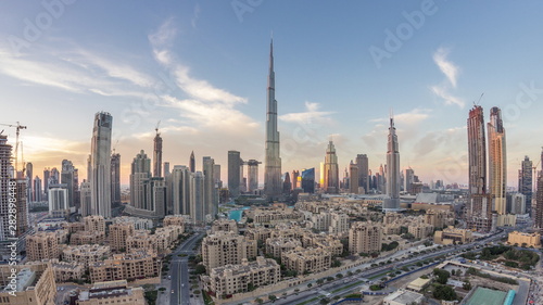 Dubai Downtown skyline day to night timelapse with Burj Khalifa and other towers paniramic view from the top in Dubai