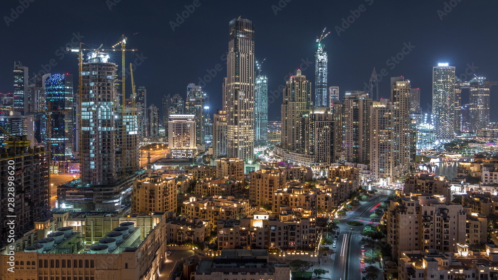 Fototapeta premium Beautiful skyline of Dubai downtown and Business bay with modern architecture night timelapse.