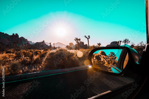 car on road in sunset