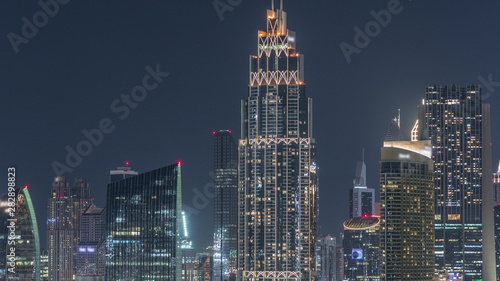 Aerial nighttime cityscape with illuminated architecture of Dubai downtown timelapse  United Arab Emirates.