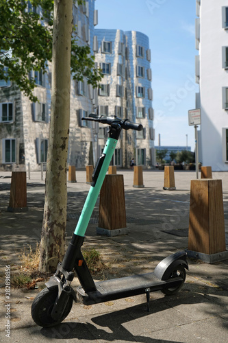 E-Scooter in front of the New Custom Houses (Neuer Zollhof) in the Media Harbour (Medienhafen) of Duesseldorf