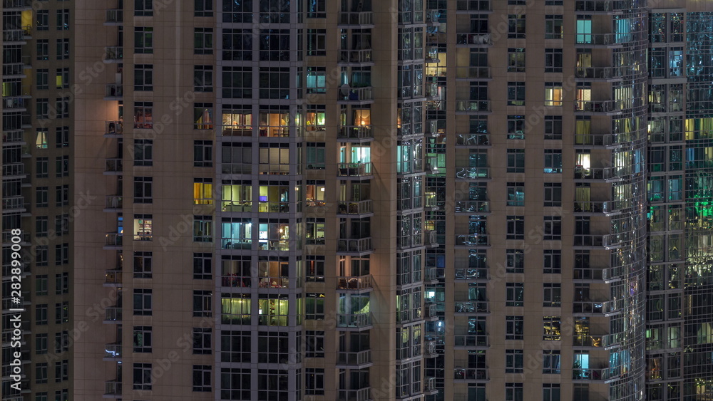Windows of the multi-storey building with lighting inside and moving people in apartments timelapse. Windows of the multi-storey building with lighting inside and moving people in apartments timelapse.