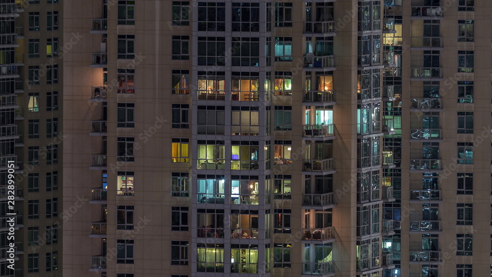 Windows of the multi-storey building with lighting inside and moving people in apartments timelapse. Windows of the multi-storey building with lighting inside and moving people in apartments timelapse.