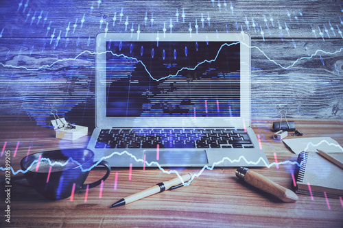 Multi exposure of graph and financial info and work space with computer background. Concept of international online trading.