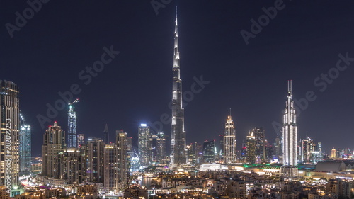 Dubai Downtown skyline night timelapse with Burj Khalifa and other towers paniramic view from the top in Dubai