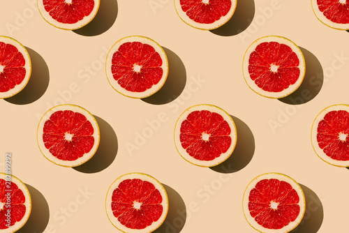 Fototapeta Naklejka Na Ścianę i Meble -  Grapefruit slices pattern on beige yellow background.