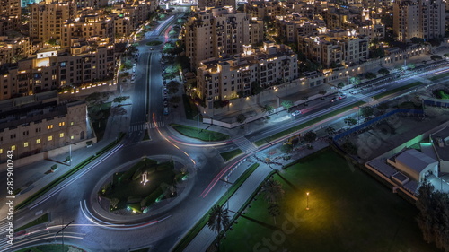 Aerial view of a roundabout circle road in Dubai downtown from above night timelapse. Dubai, United Arab Emirates.