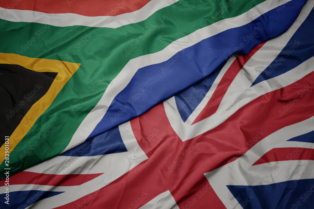 waving colorful flag of great britain and national flag of south africa. waving colorful flag of great britain and national flag of south africa.