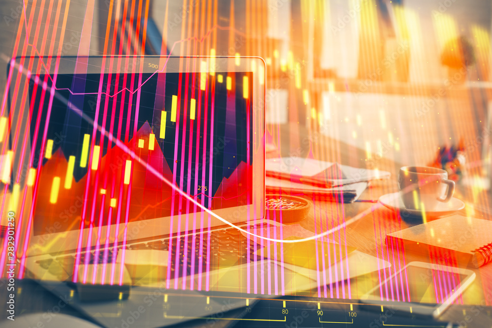 Financial graph colorful drawing and table with computer on background. Double exposure. Concept of international markets. Financial graph colorful drawing and table with computer on background. Double exposure. Concept of international markets.