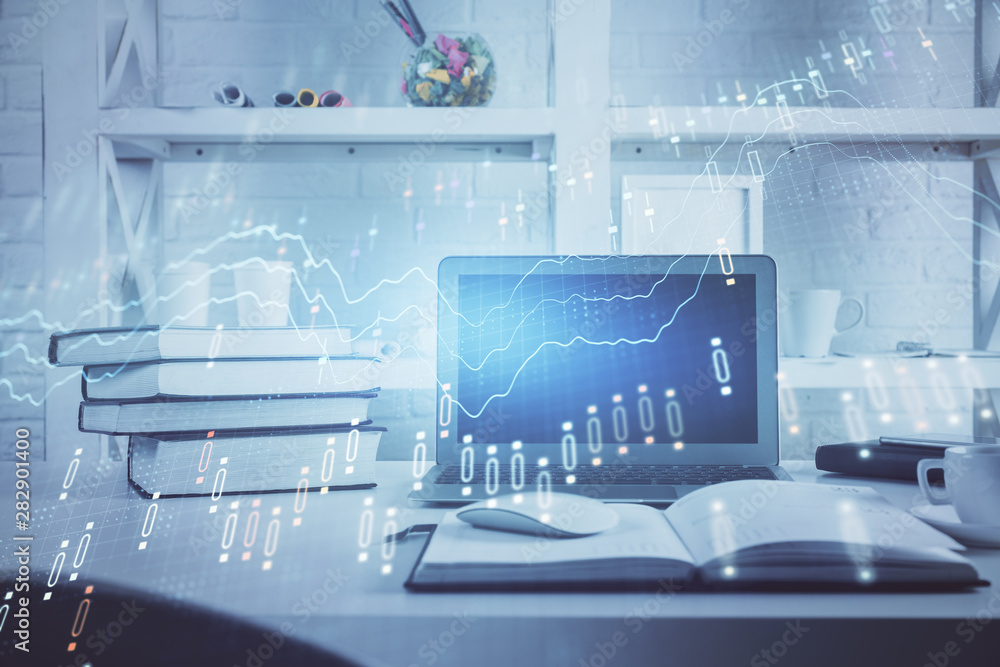 Forex Chart hologram on table with computer background. Double exposure. Concept of financial markets. Forex Chart hologram on table with computer background. Double exposure. Concept of financial markets.