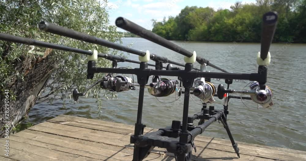 Carp fishing, rodpod on a wooden platform on a pond Carp fishing, rodpod on a wooden platform on a pond