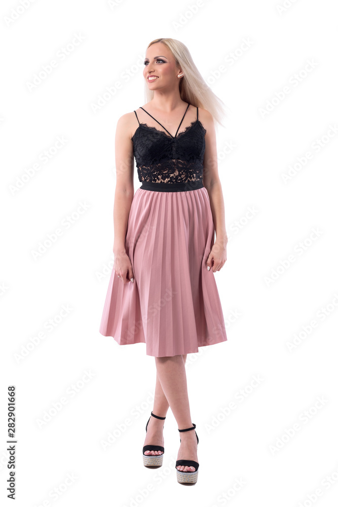 Stunning blonde happy young woman in summer clothes smiling and looking up. Full body isolated on white background. Stunning blonde happy young woman in summer clothes smiling and looking up. Full body isolated on white background.