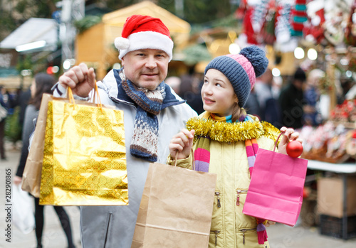 Happy girl and father with shopping bags
