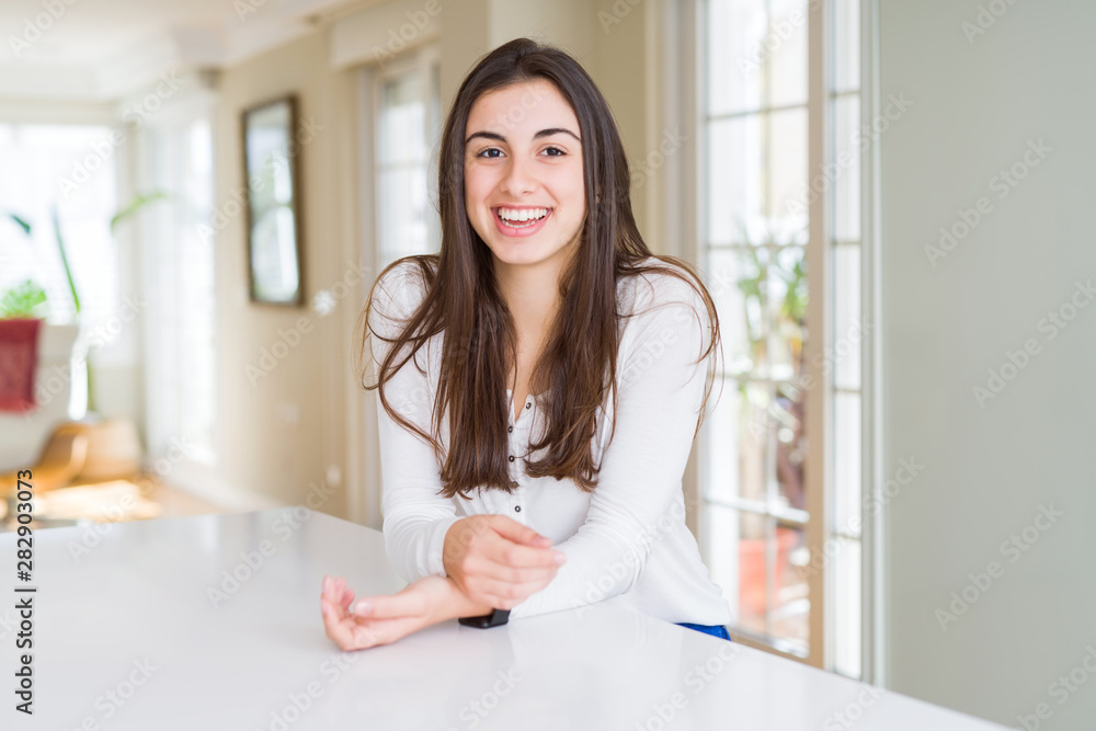 Beautiful young brunette woman smiling cheerful looking at the camera with a big smile on face showing teeth Beautiful young brunette woman smiling cheerful looking at the camera with a big smile on face showing teeth